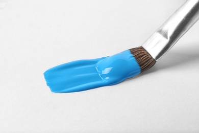 Photo of Brush with color paint and stroke on white background