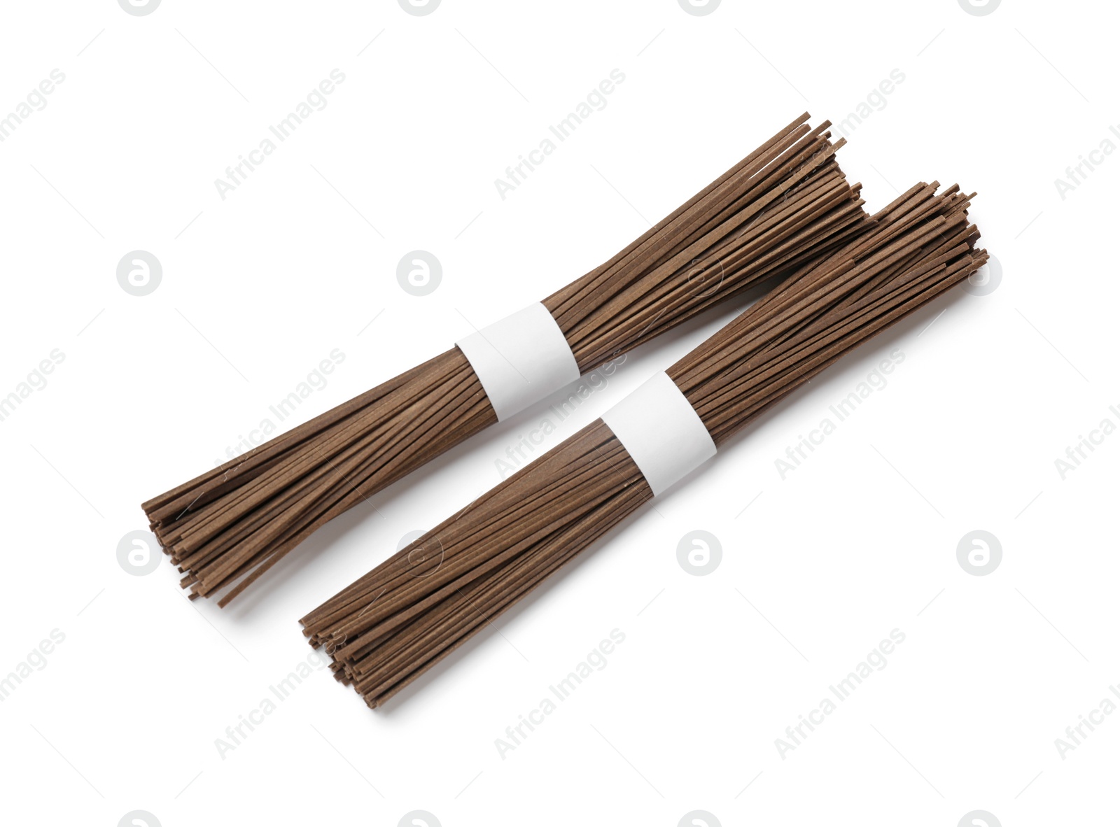 Photo of Uncooked buckwheat noodles (soba) isolated on white, top view