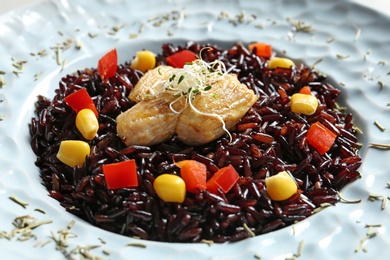 Photo of Boiled brown rice with meat in plate, closeup