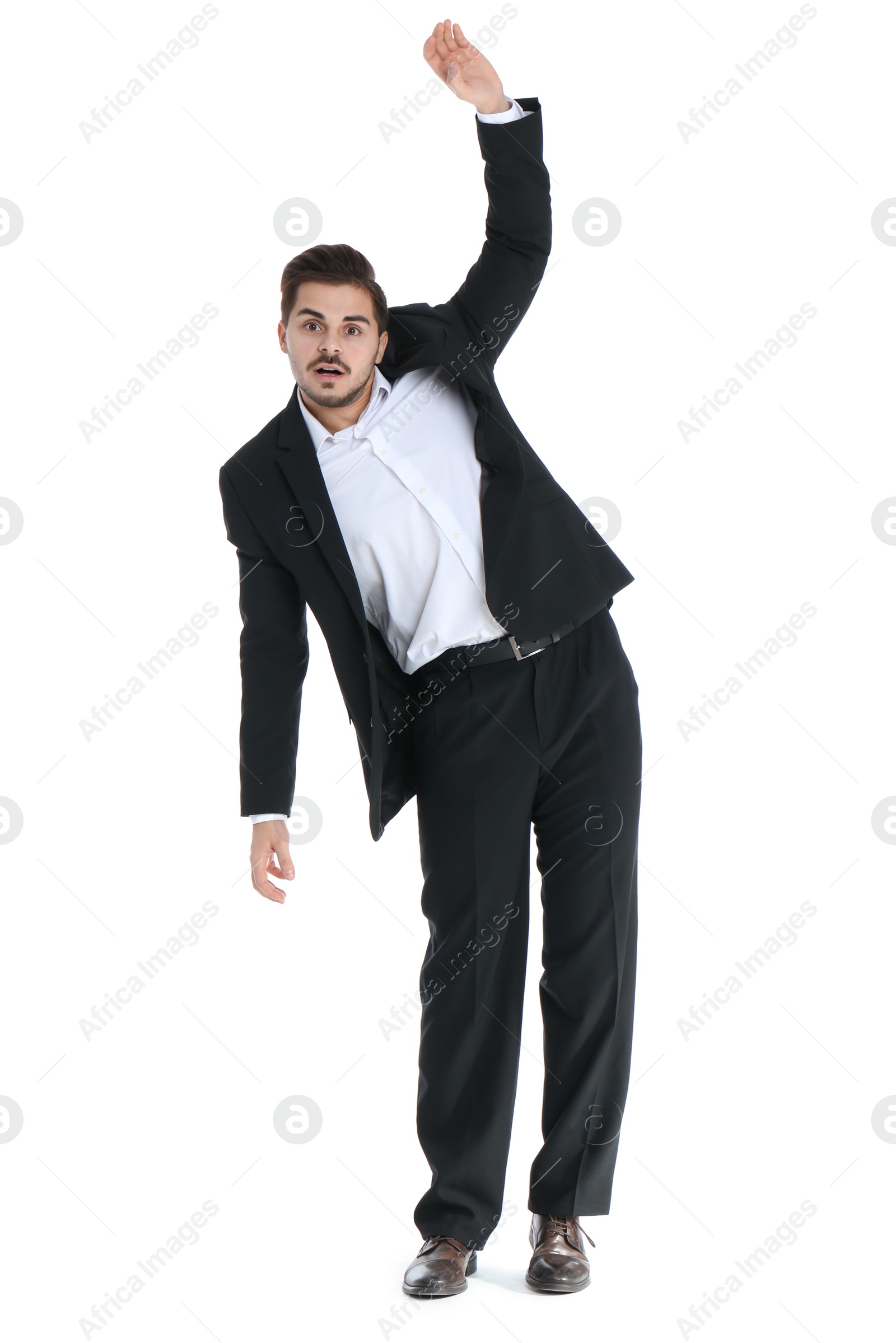 Photo of Young businessman attracted to magnet on white background