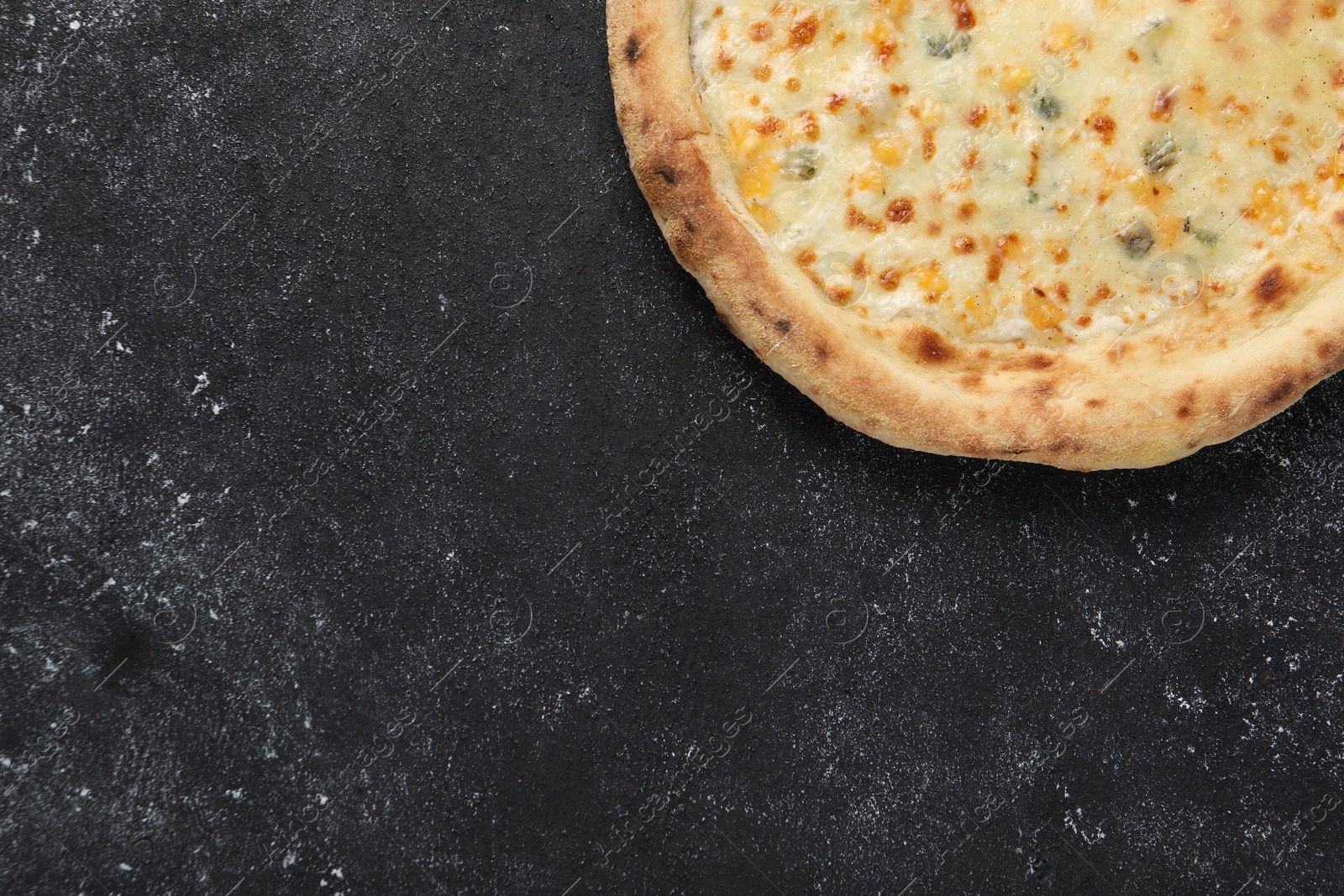 Photo of Delicious cheese pizza on black textured table, top view. Space for text