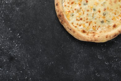 Photo of Delicious cheese pizza on black textured table, top view. Space for text