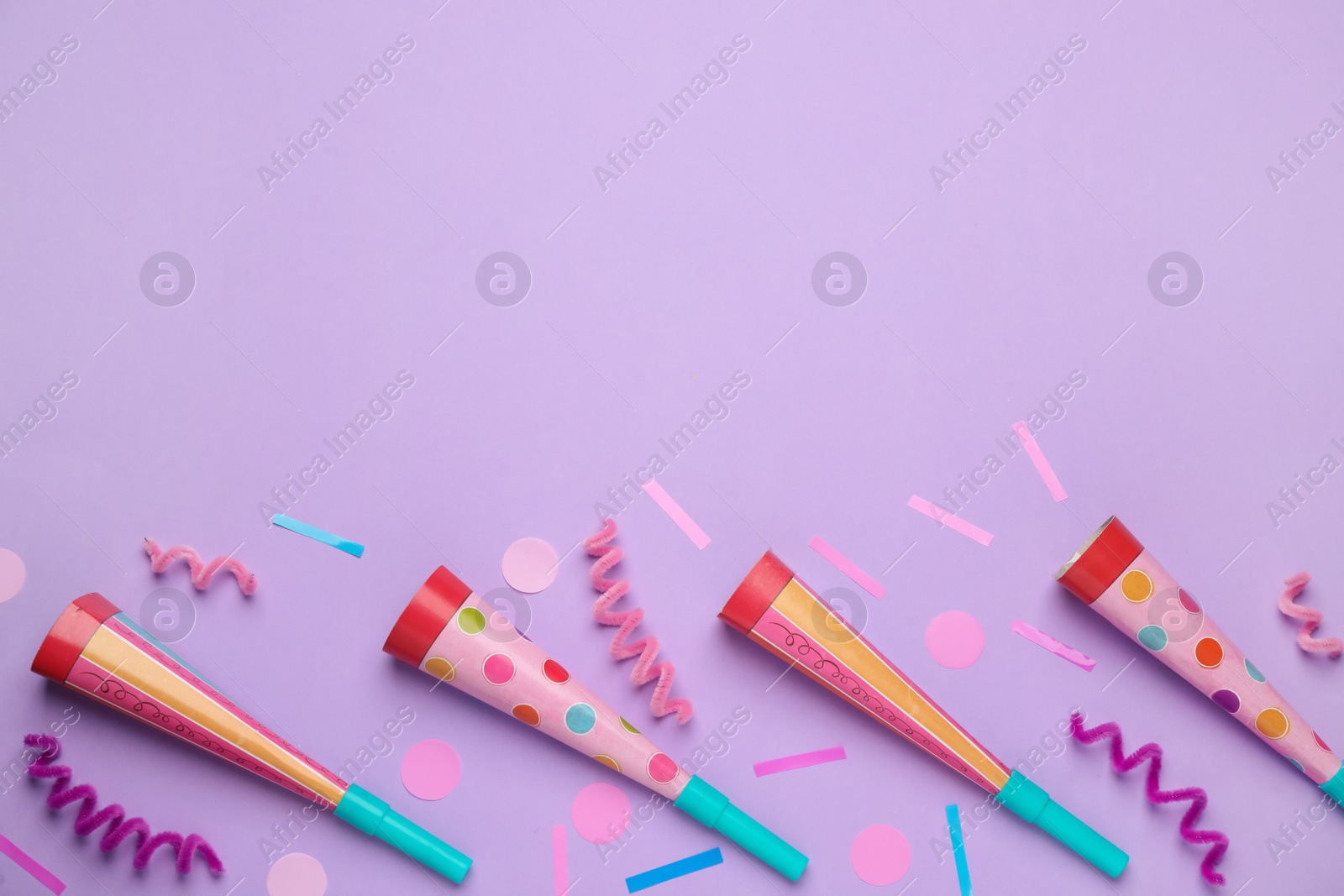 Photo of Flat lay composition with party items on pale violet background, space for text