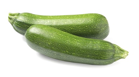 Photo of Fresh raw ripe zucchinis on white background