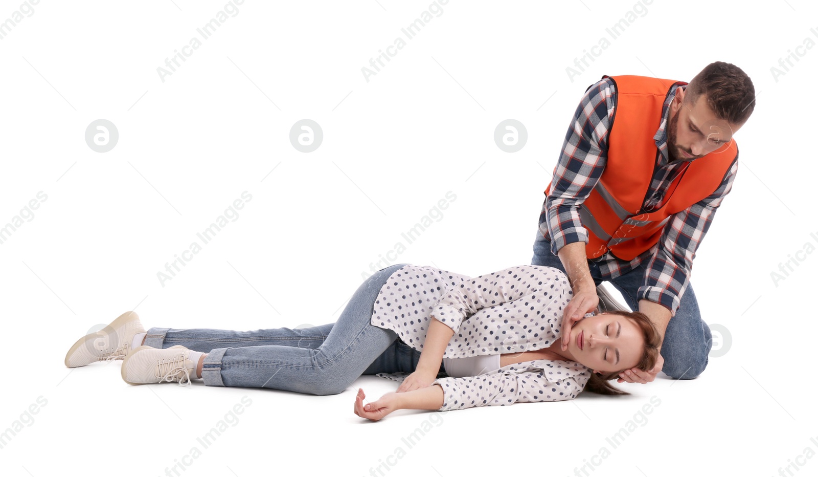 Photo of Paramedic in uniform performing first aid on unconscious woman against white background