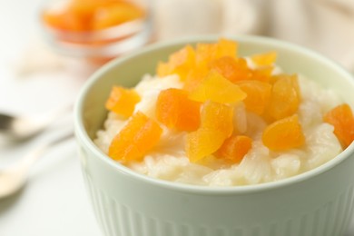 Delicious rice pudding with dried apricots, closeup