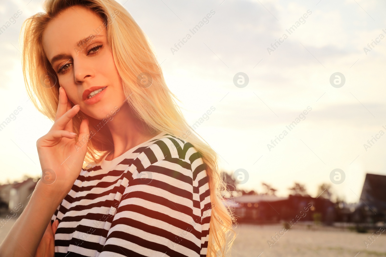 Photo of Beautiful young woman outdoors on sunny day, space for text