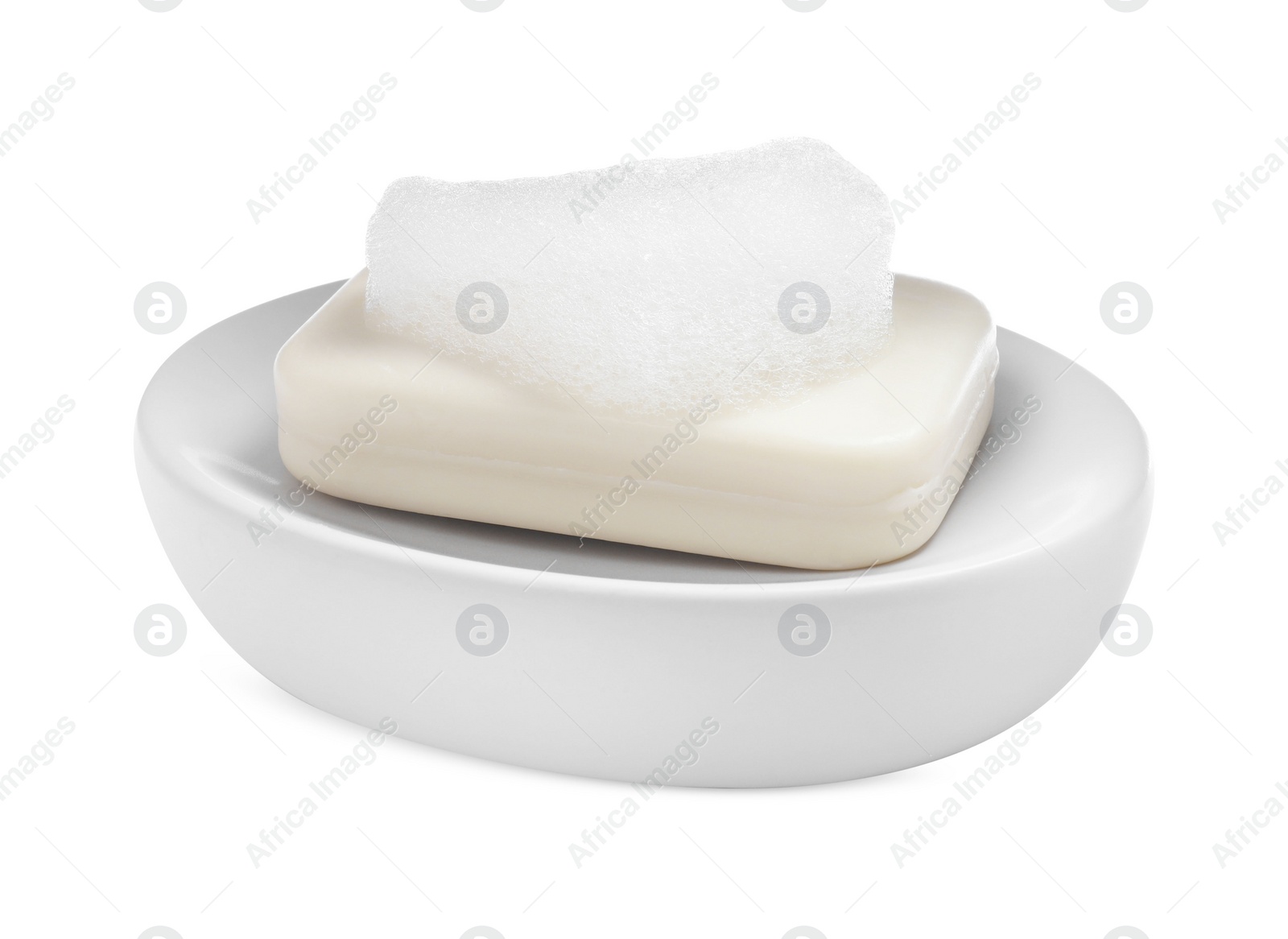 Photo of Soap bar with fluffy foam in holder on white background