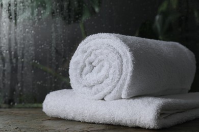 Photo of White terry towels on table in bathroom