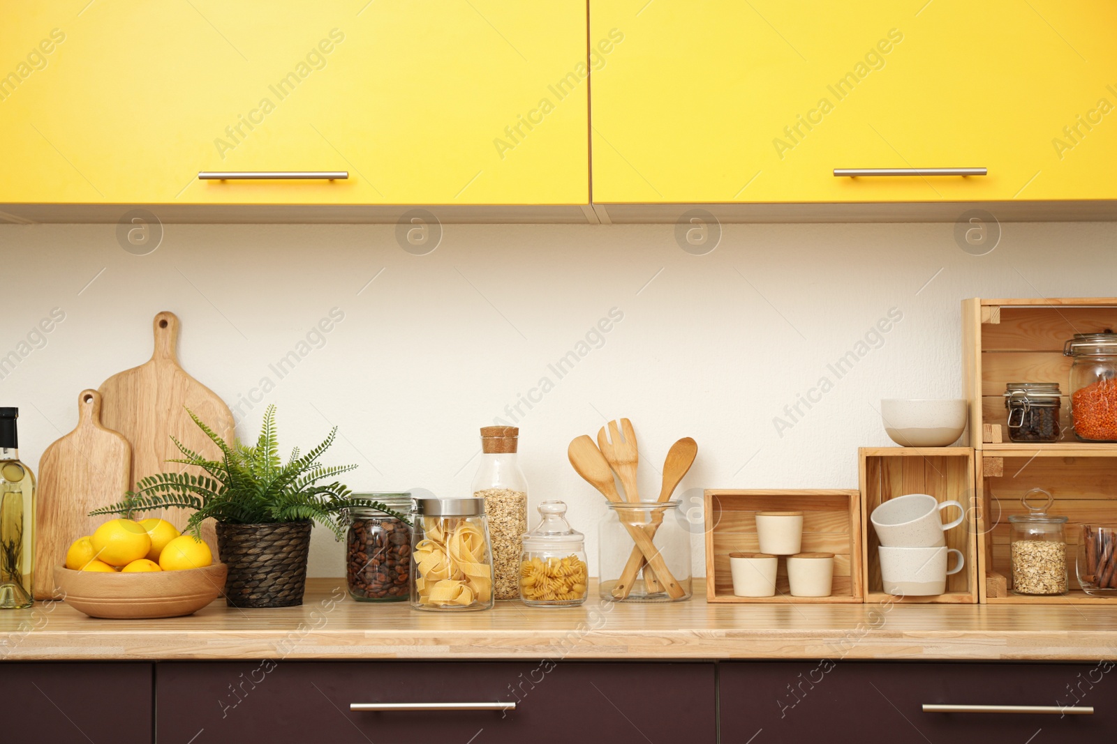 Photo of Stylish kitchen interior with wooden countertop and wall cabinets