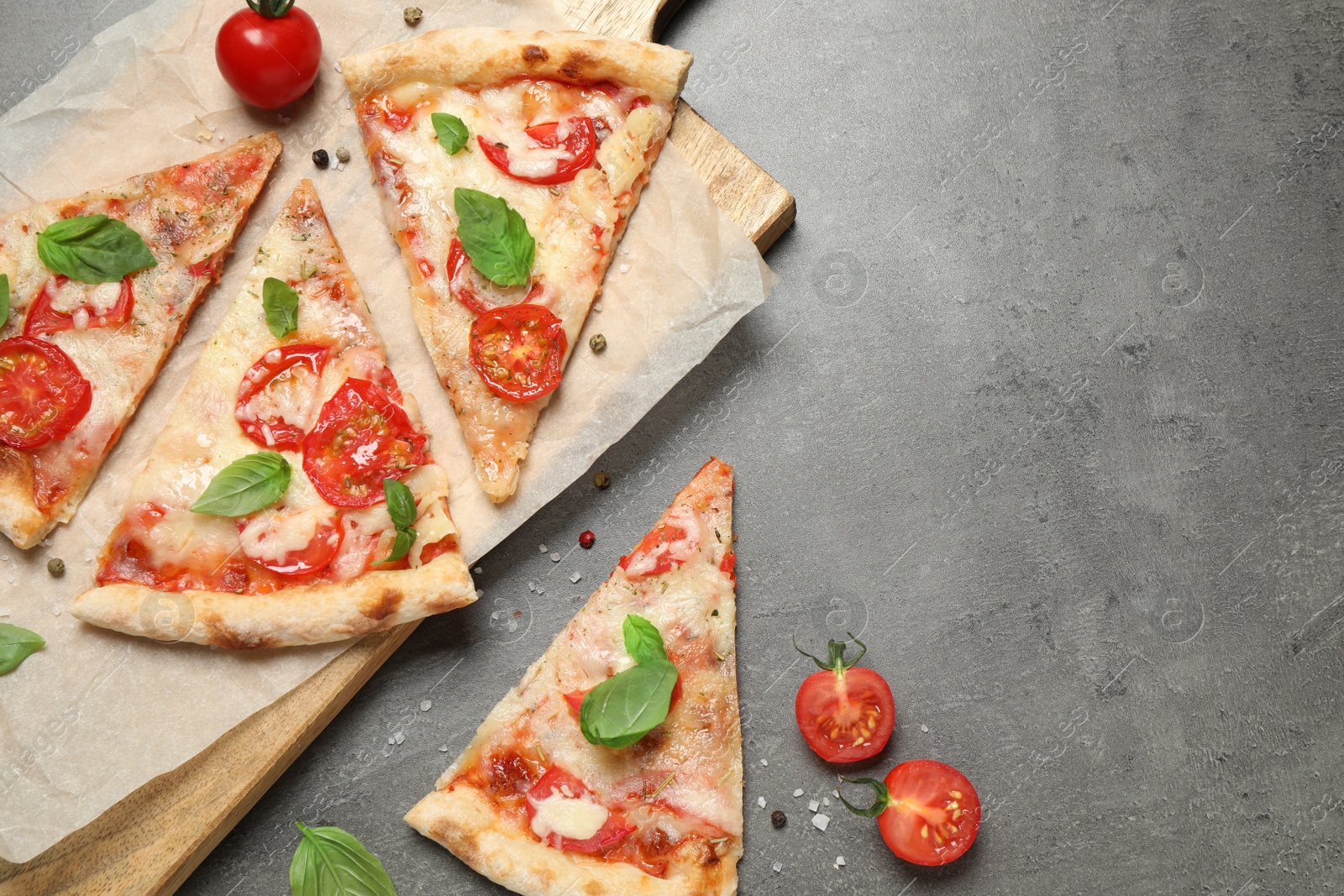 Photo of Slices of delicious pizza Margherita on grey table, flat lay. Space for text