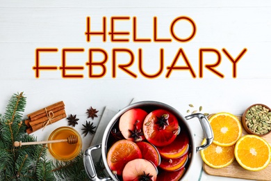 Image of Hello February greeting card. Flat lay composition with delicious mulled wine and ingredients on white wooden table
