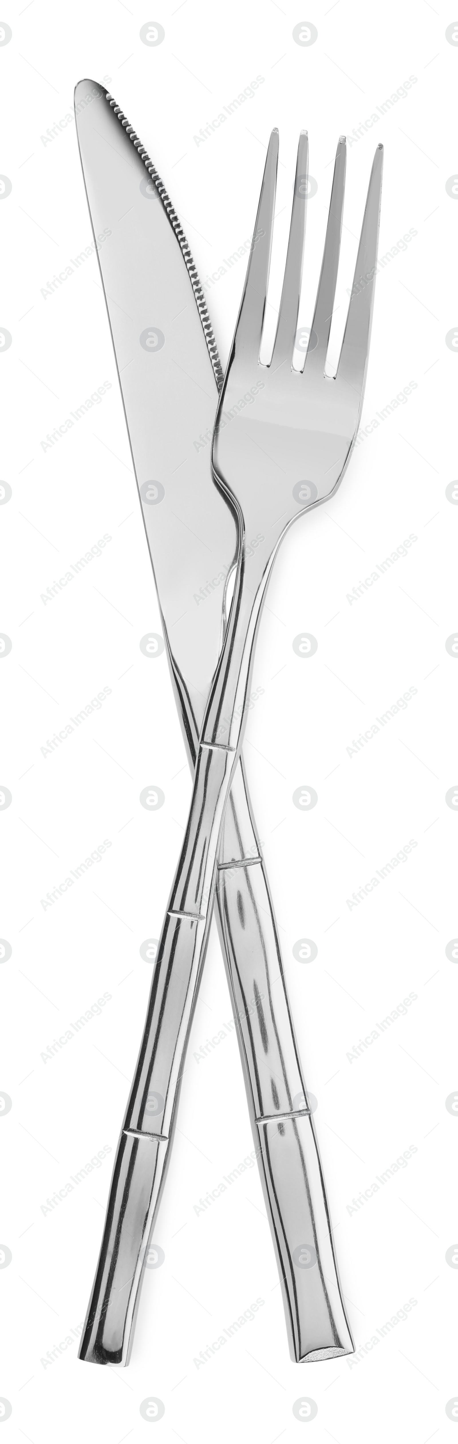 Photo of Fork and knife isolated on white, top view. Stylish shiny cutlery set