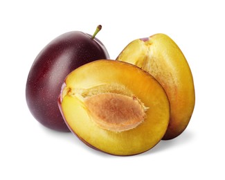 Whole and cut ripe plums on white background