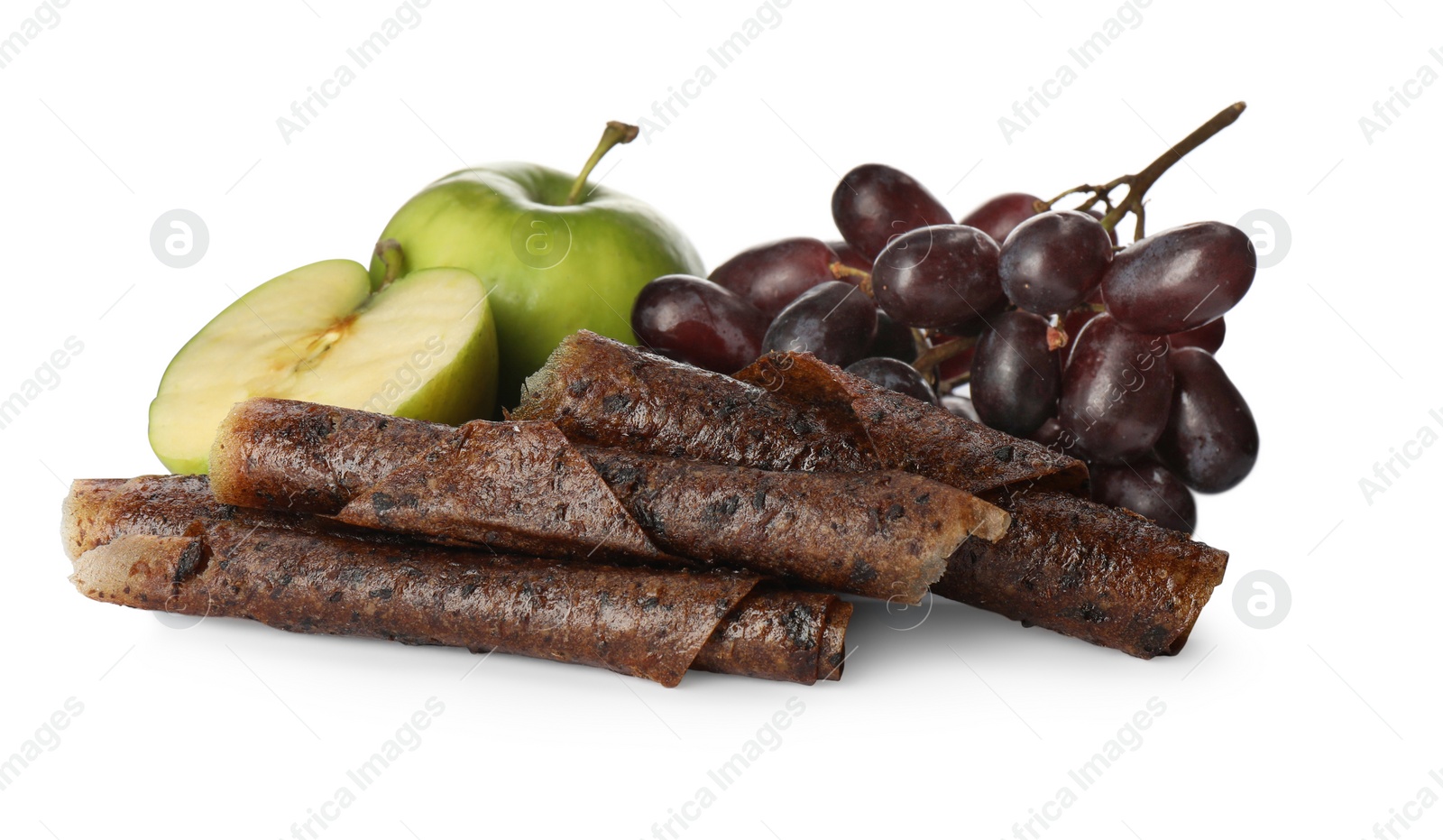 Photo of Delicious fruit leather rolls, apples and grapes on white background