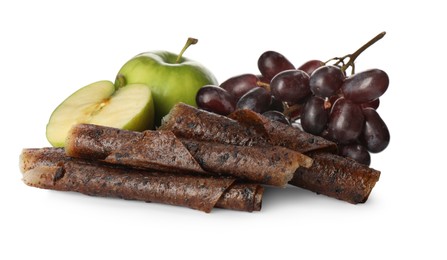 Photo of Delicious fruit leather rolls, apples and grapes on white background