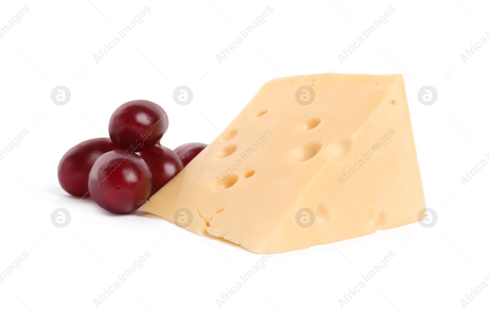 Photo of Piece of delicious cheese and grapes isolated on white