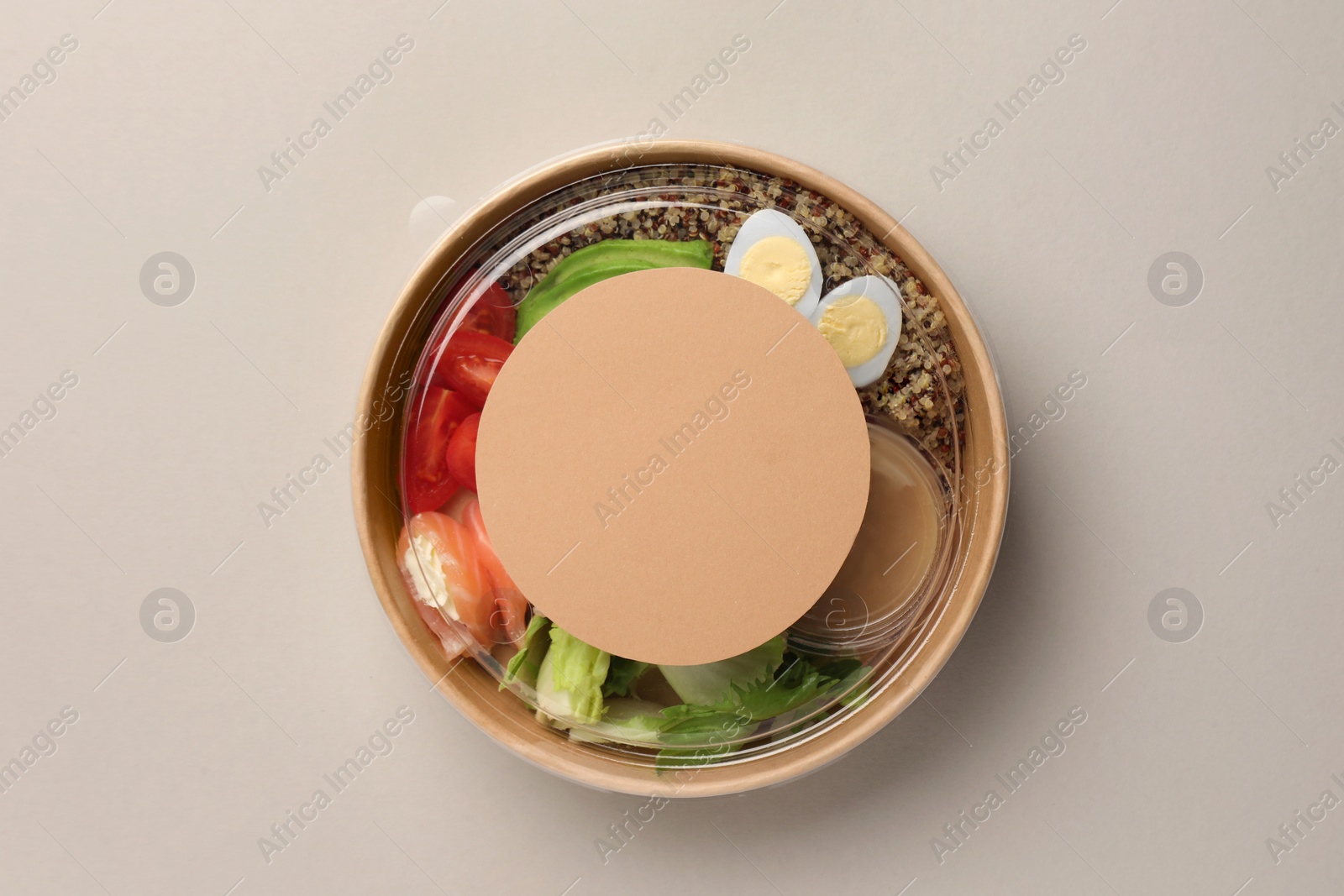 Photo of Tasty food in container on light background, top view. Space for text