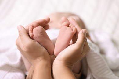 Photo of Mother and her newborn baby on bed, closeup. Space for text
