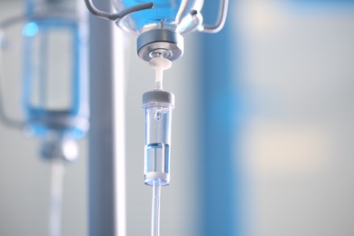 Photo of IV drip chamber against blurred light background