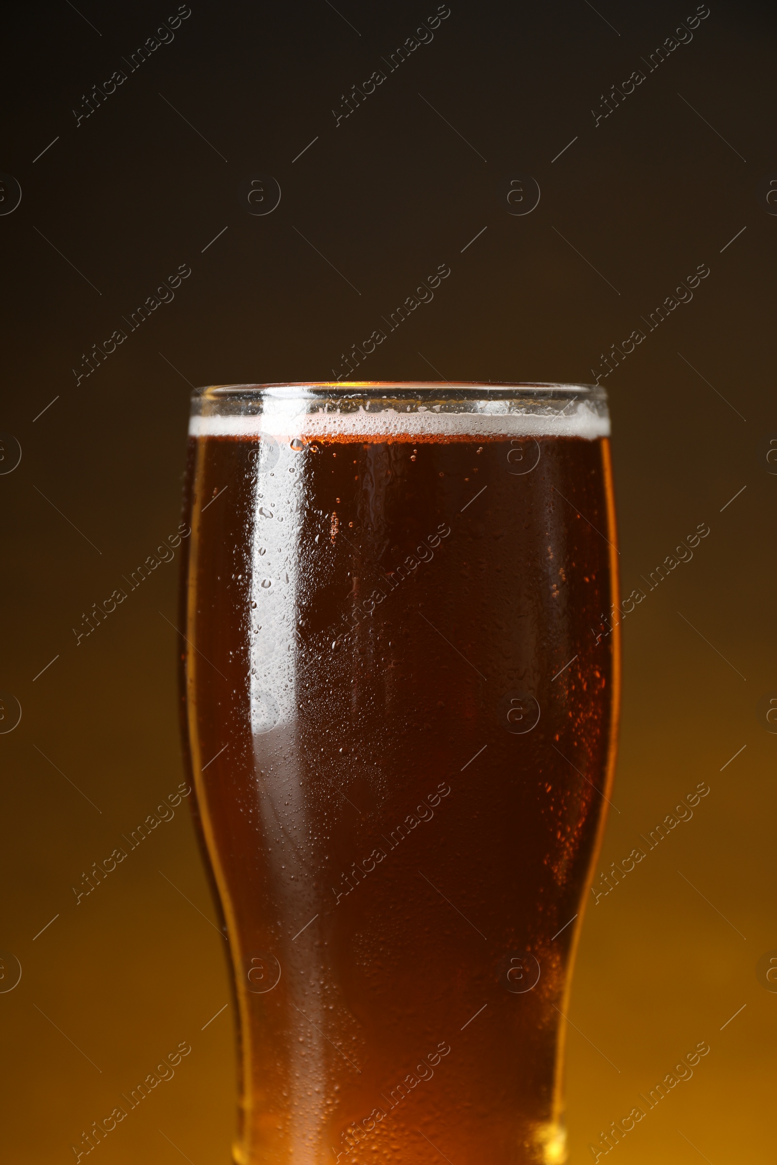 Photo of Glass with fresh beer against dark background, closeup