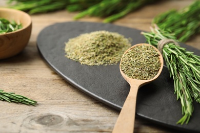 Photo of Dried rosemary and fresh twigs on wooden table