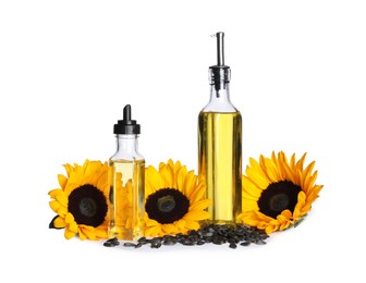 Photo of Sunflower cooking oil, seeds and yellow flowers on white background