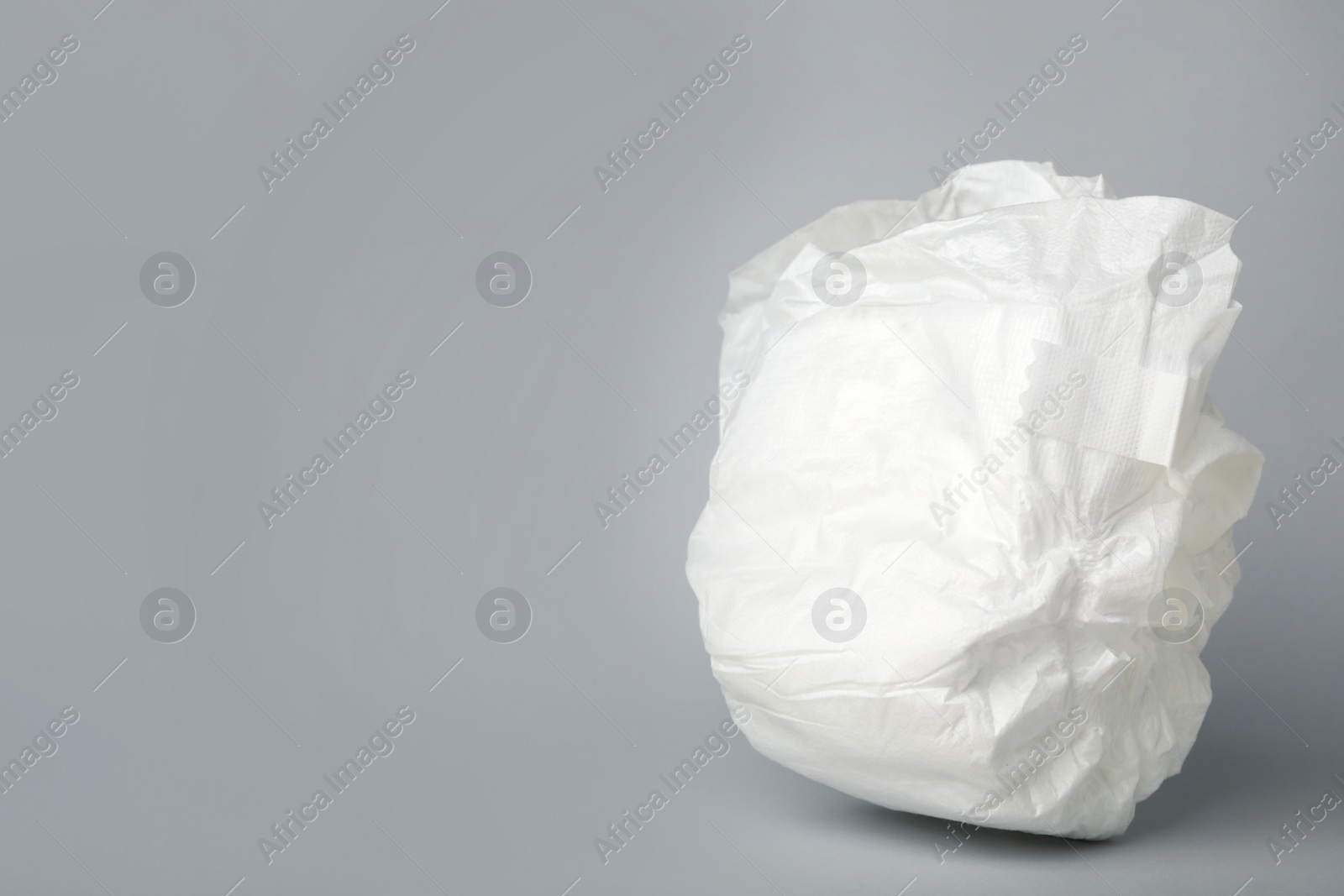 Photo of Baby diaper on light grey background. Space for text