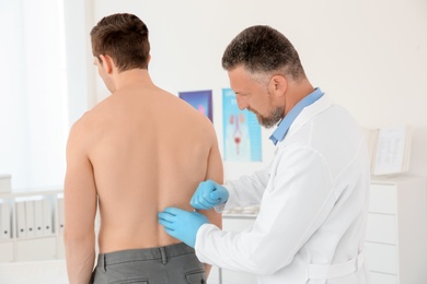 Urologist examining patient in hospital