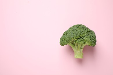 Photo of Fresh tasty broccoli on pink background, top view. Space for text