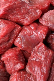 Pieces of raw beef meat as background, closeup