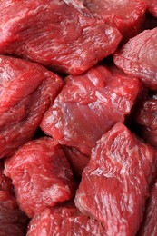 Photo of Pieces of raw beef meat as background, closeup