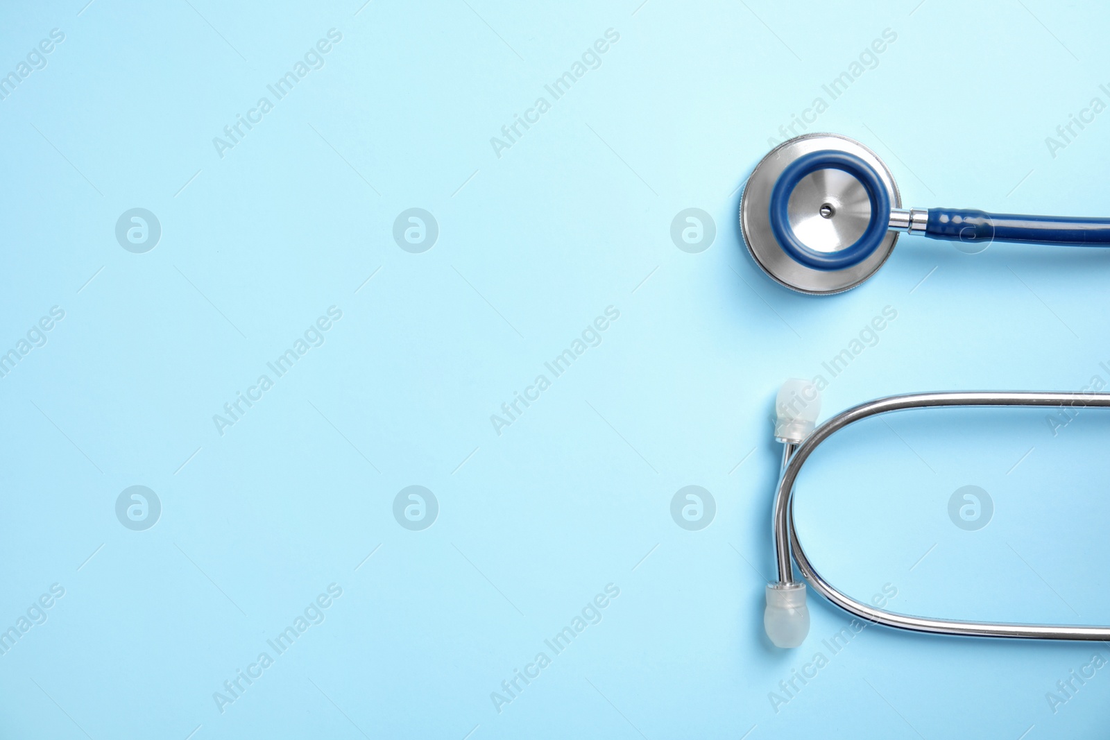 Photo of Stethoscope with space for text on color background, top view. Medical tool