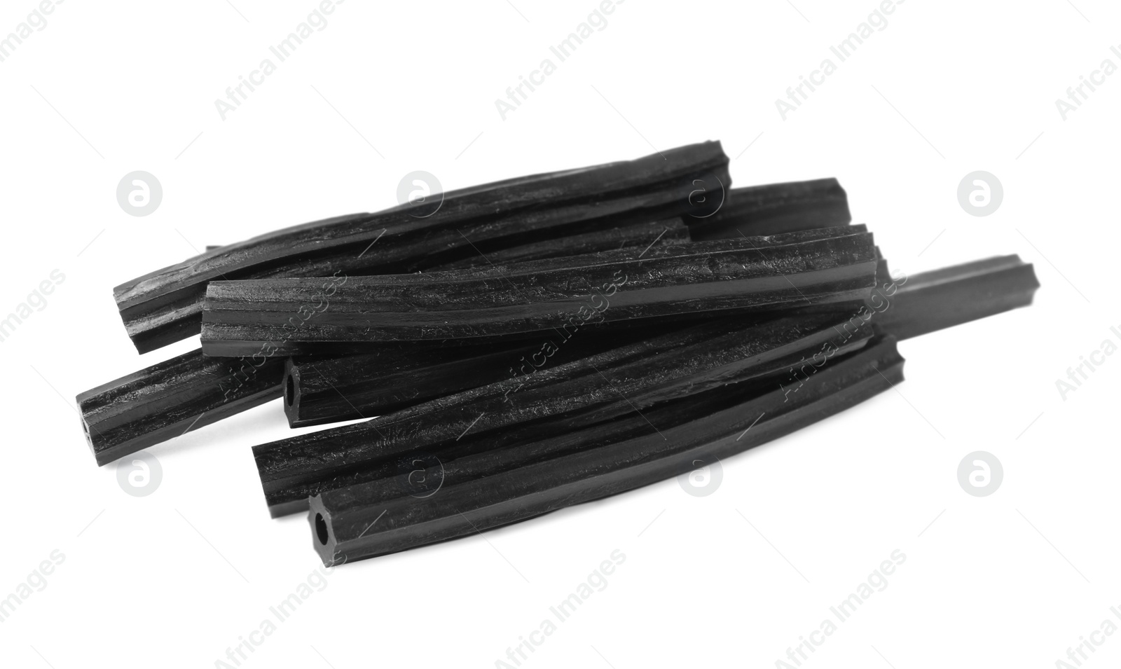Photo of Tasty black liquorice candies on white background
