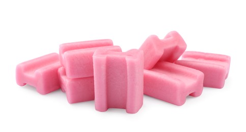 Photo of Many tasty pink chewing gums on white background