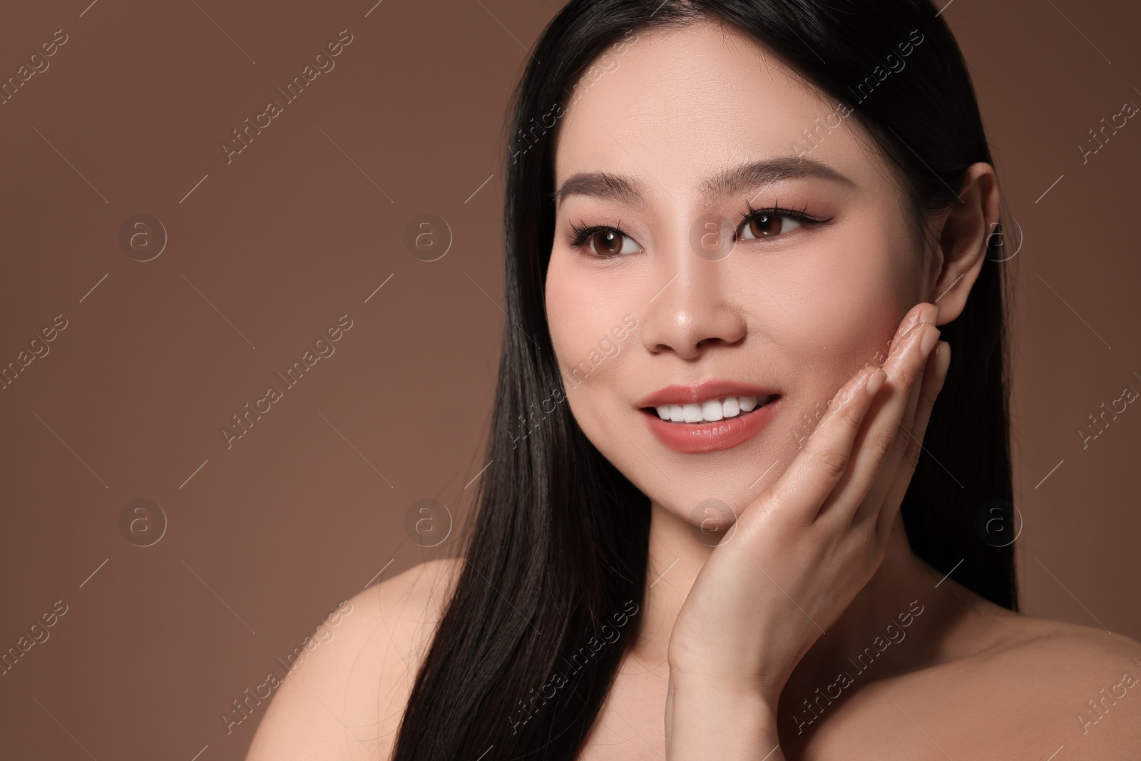 Photo of Portrait of beautiful woman on brown background