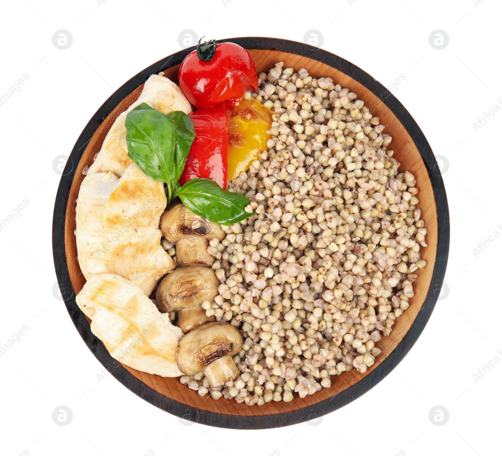 Photo of Tasty buckwheat porridge with meat and mushrooms isolated on white, top view