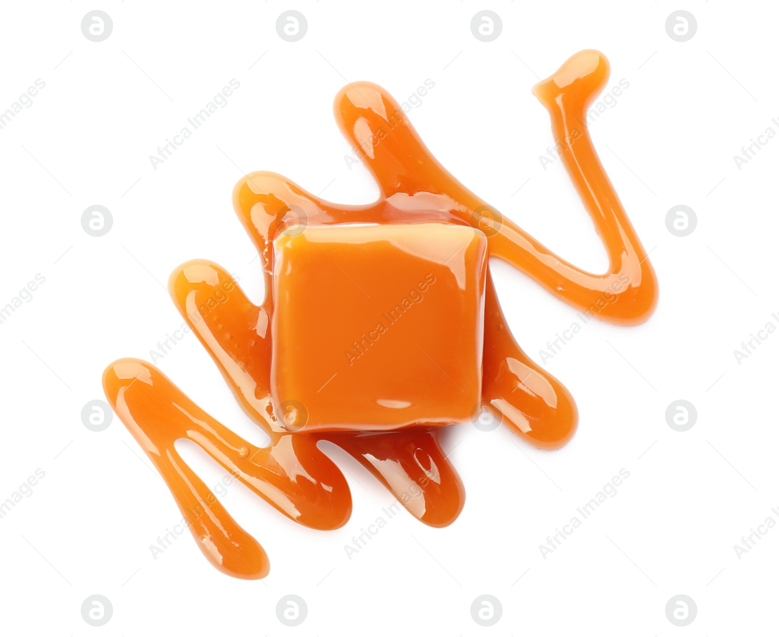 Photo of Sweet caramel candy with topping isolated on white, top view