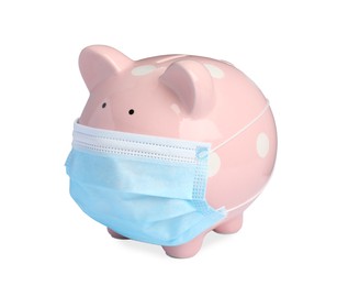 Photo of Piggy bank in protective mask on white background. Medical insurance