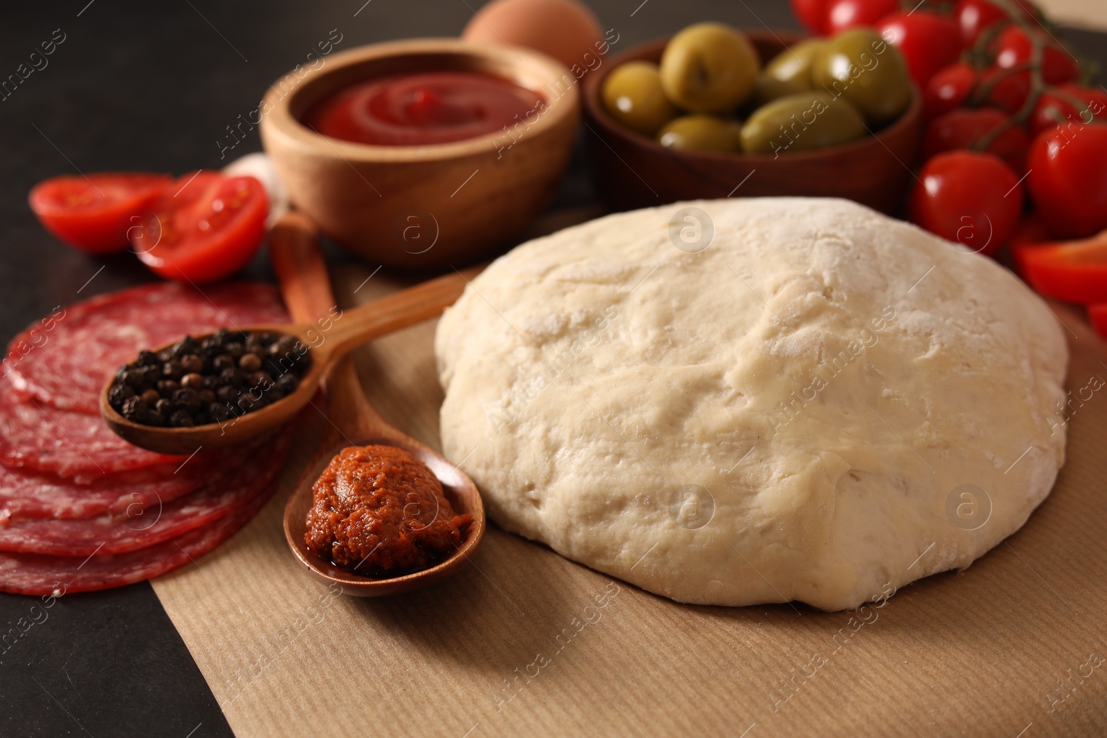 Photo of Pizza dough and products on table, closeup