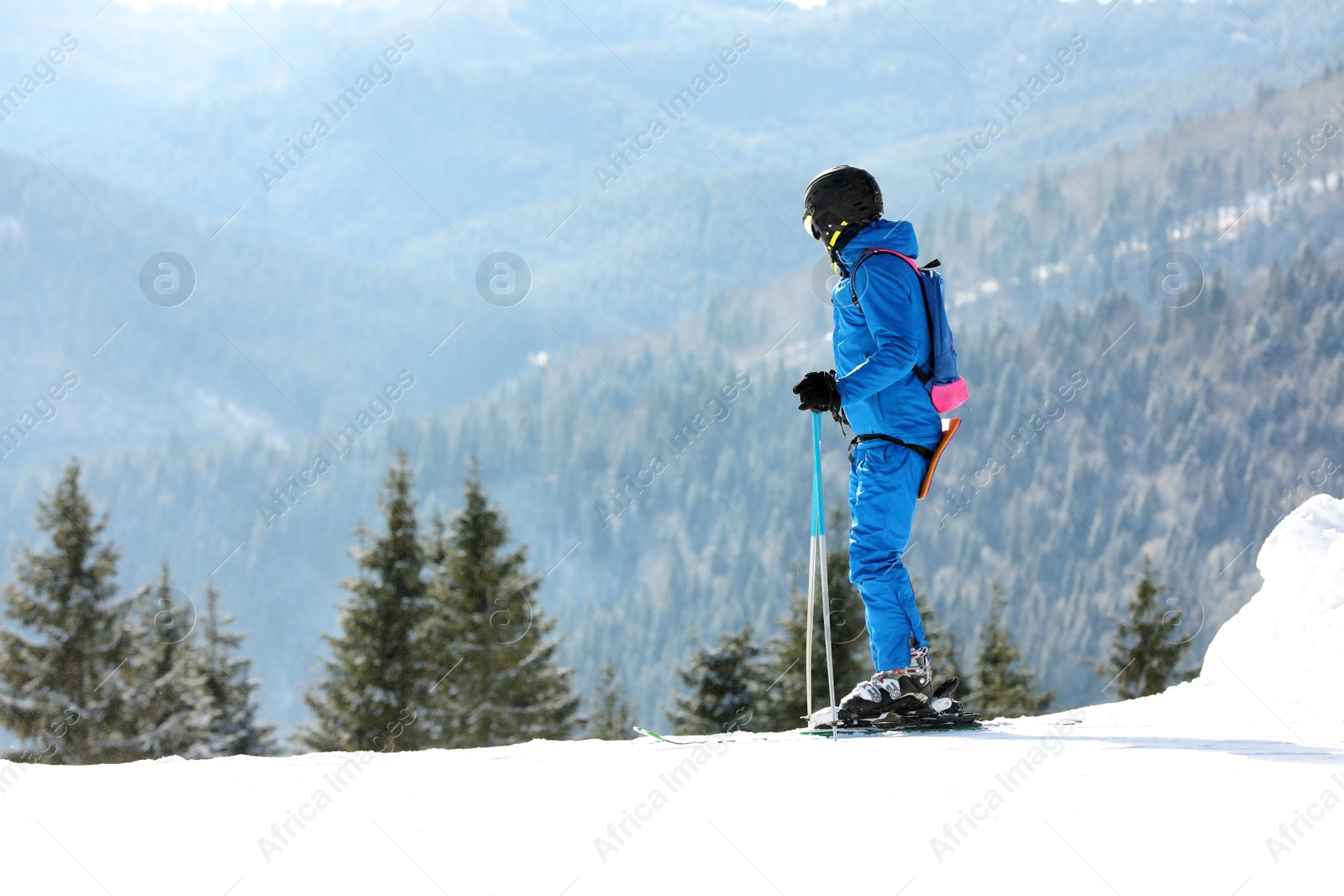 Photo of Man skiing on snowy hill in mountains, space for text. Winter vacation