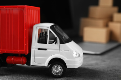 Photo of Toy truck on table. Logistics and wholesale concept