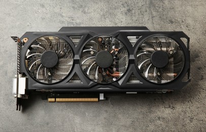 One computer graphics card on grey textured table, top view
