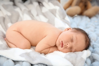 Photo of Adorable newborn baby sleeping on soft plaid