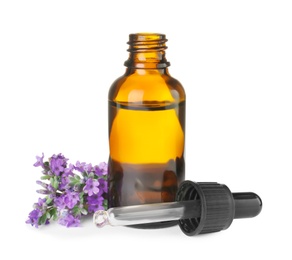 Bottle of essential oil and lavender flowers isolated on white