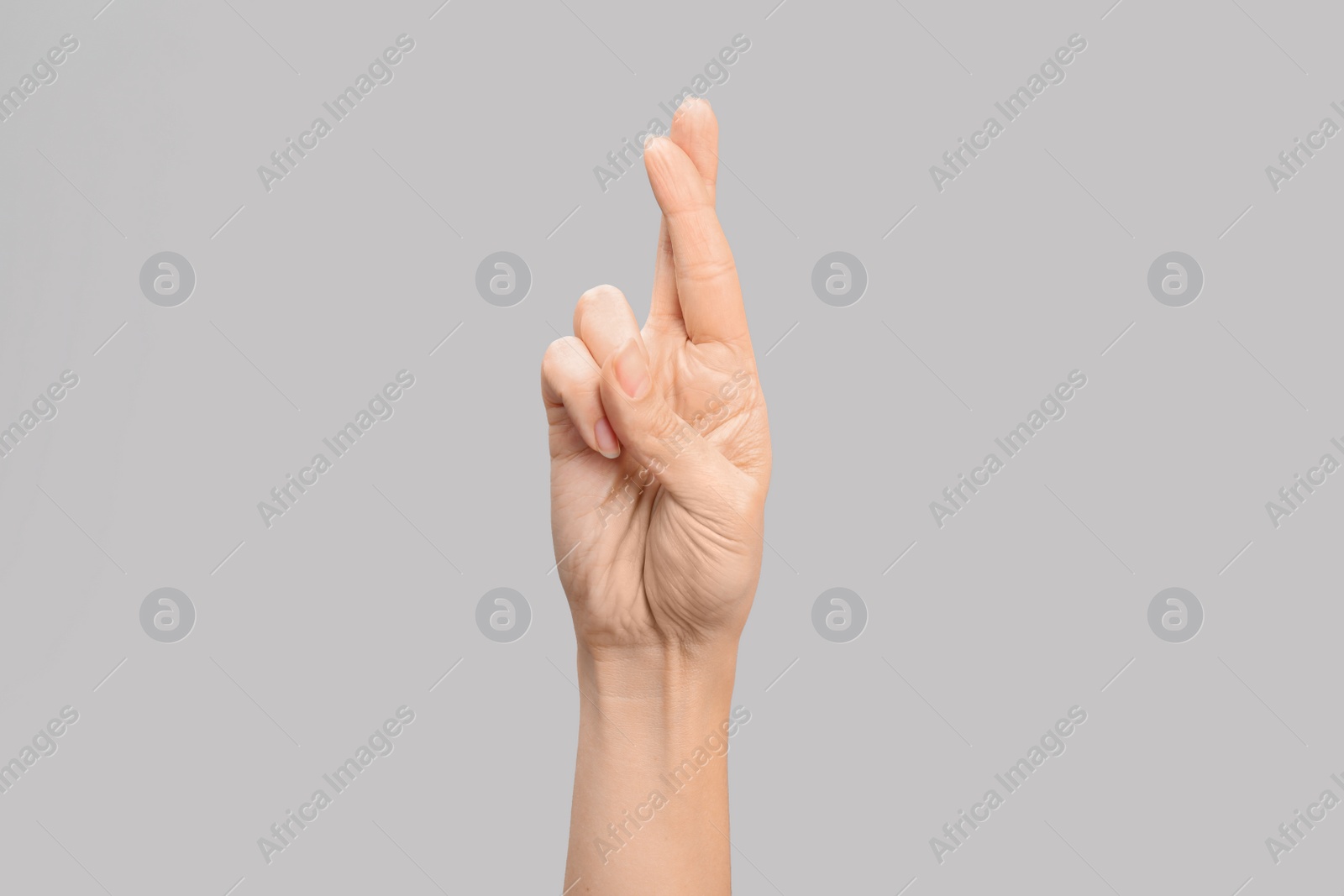 Photo of Woman showing R letter on grey background, closeup. Sign language