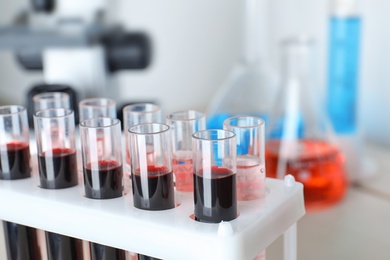 Image of Test tubes with blood samples in rack on table, closeup. Laboratory analysis