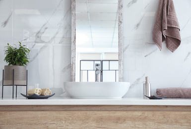 Modern bathroom interior with stylish mirror and vessel sink