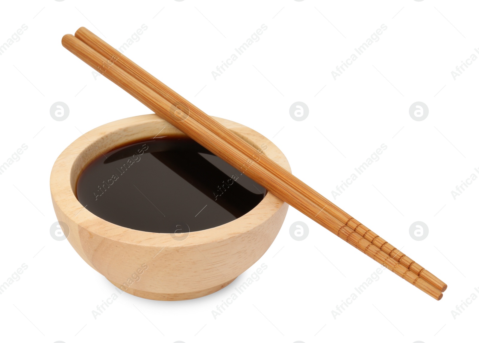 Photo of Tasty soy sauce in bowl and chopsticks isolated on white