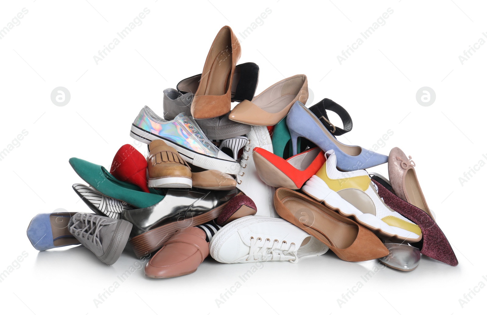 Photo of Pile of female shoes on white background